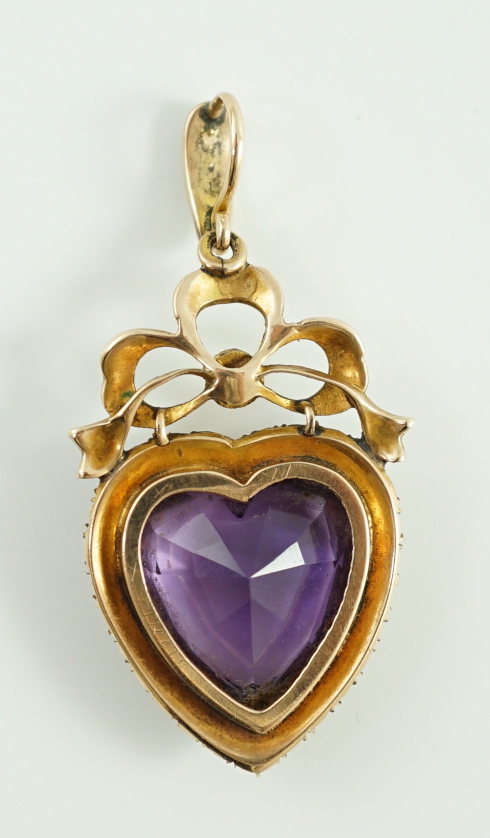 A late Victorian gold, heart shaped amethyst and seed pearl set drop pendant